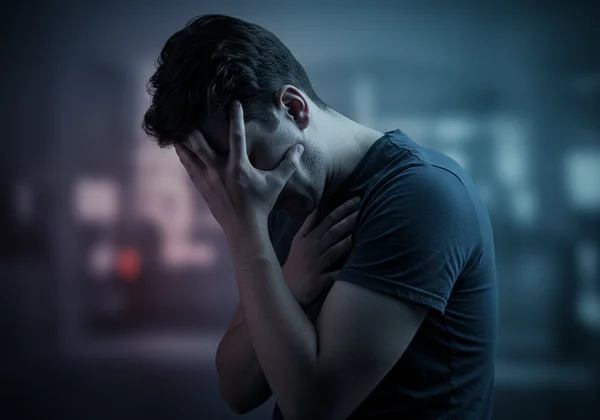 Person experiencing intense emotional pain from rejection.